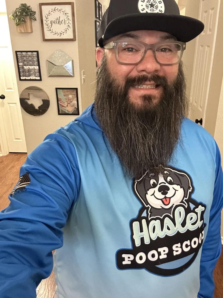 Haslet Poop Scoop LLC Owner Selfie with Long Sleeve Uniform Shirt. Background is inside of a house.